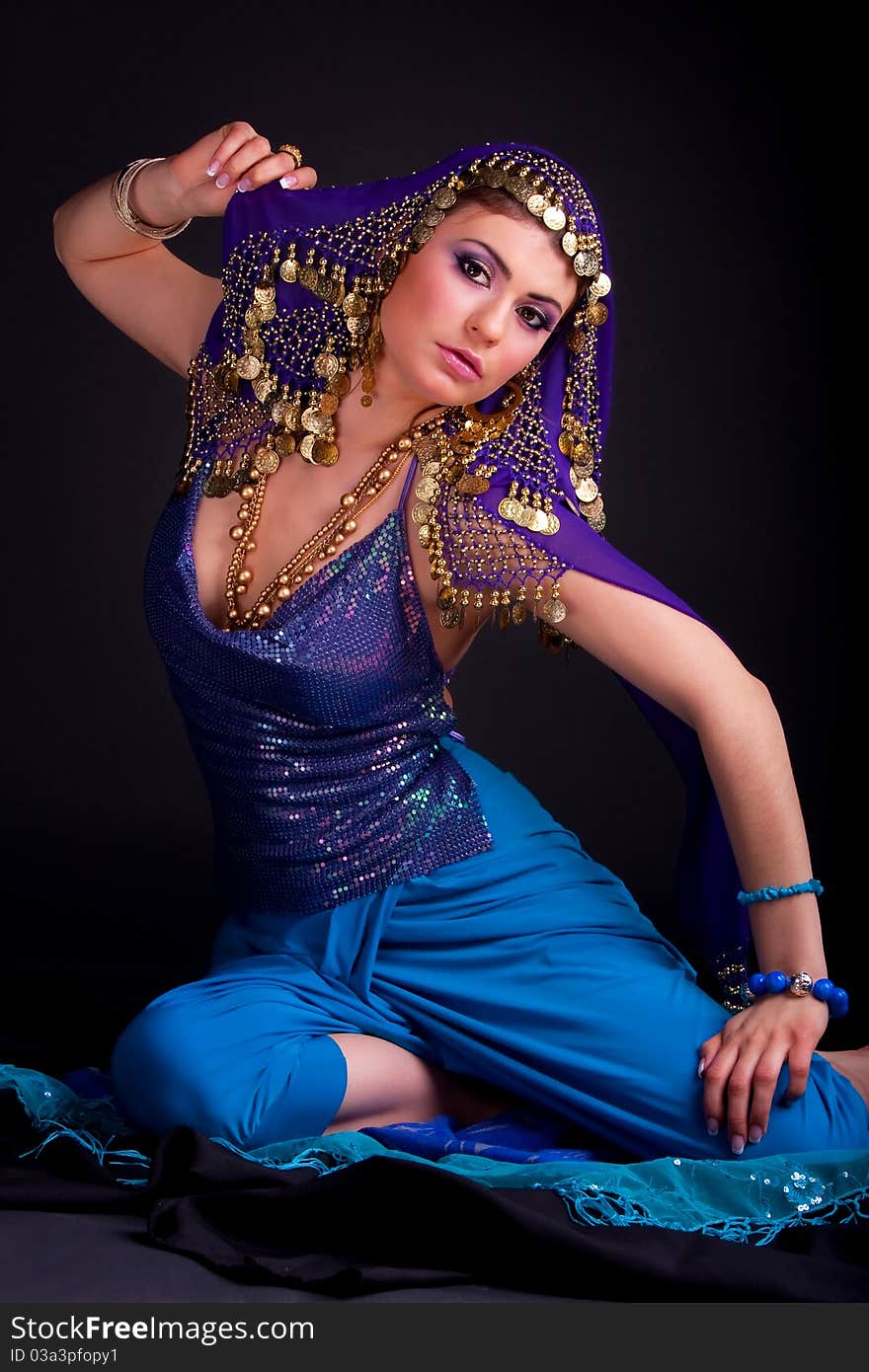 Beautiful girl in a stylized ethnic costume and shawl