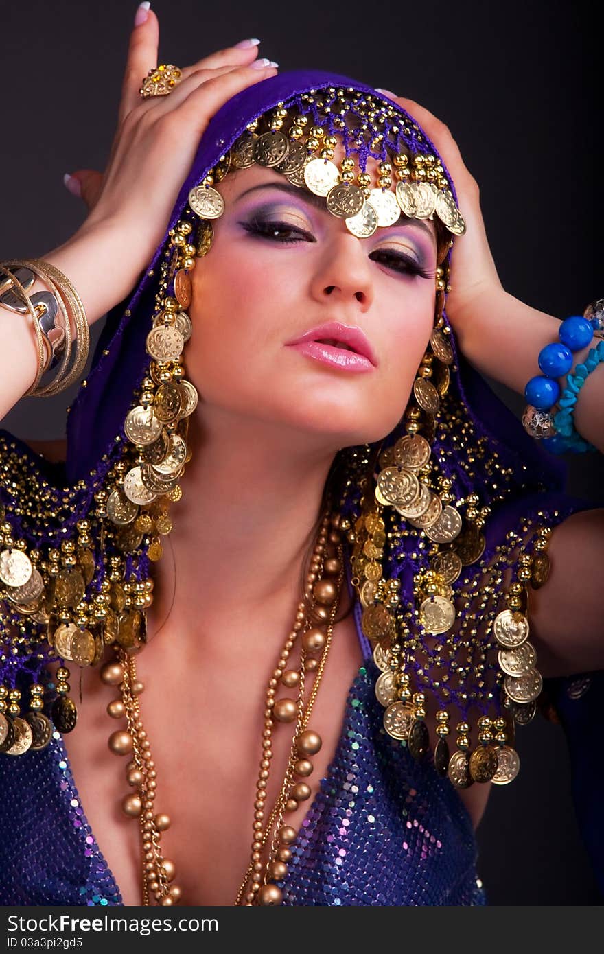 Beautiful girl in a stylized ethnic costume and shawl