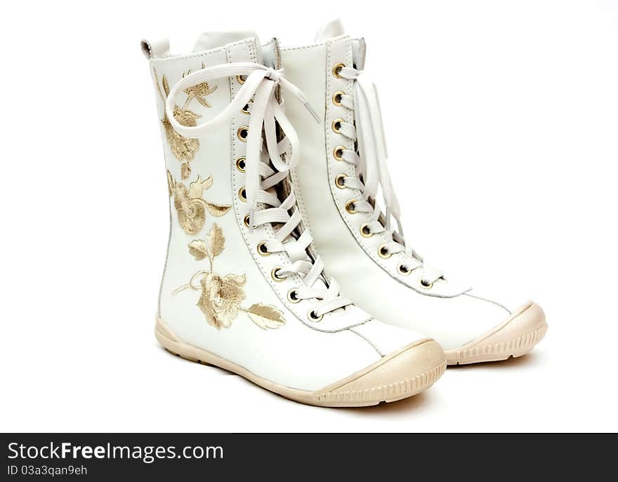 Pair of white female boots on the white background