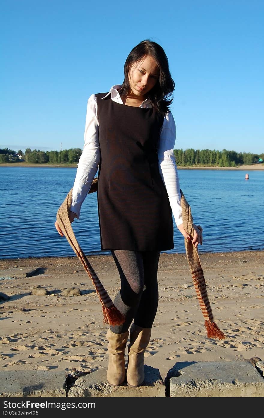 Woman standing on the river shore