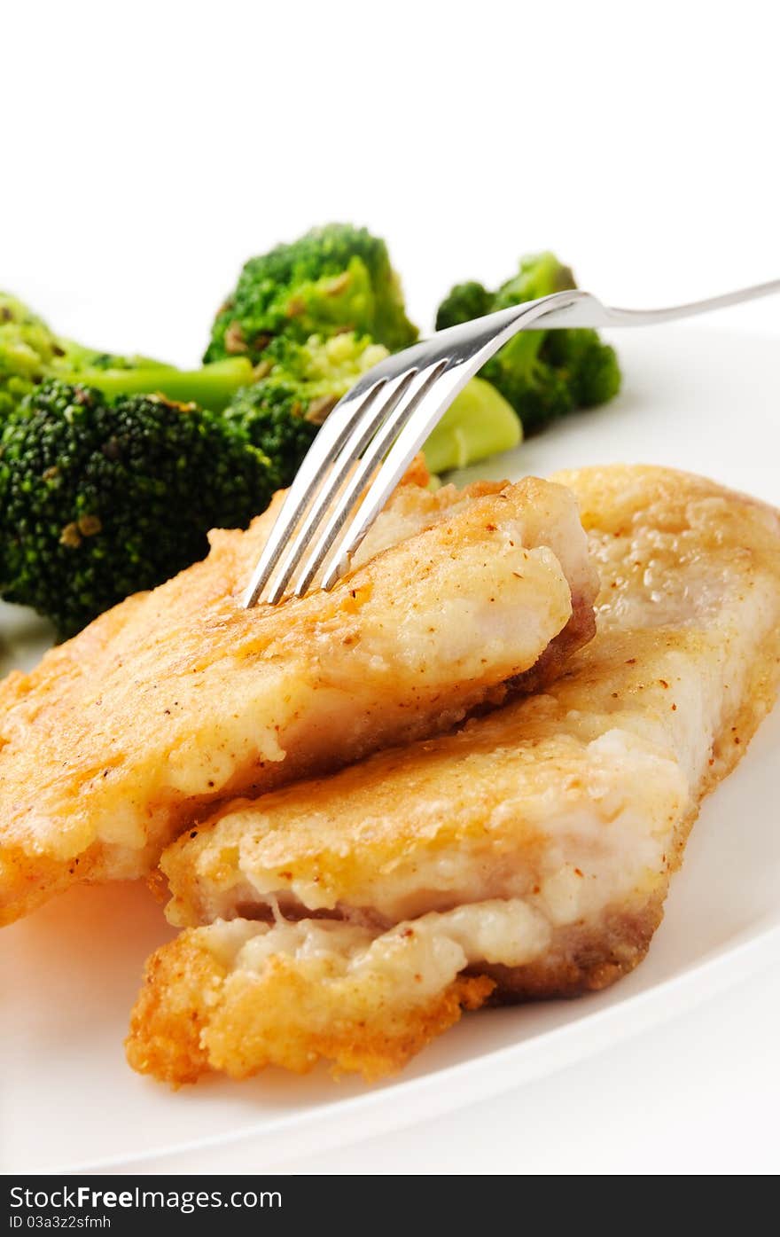 Broccoli and fried fish on white background