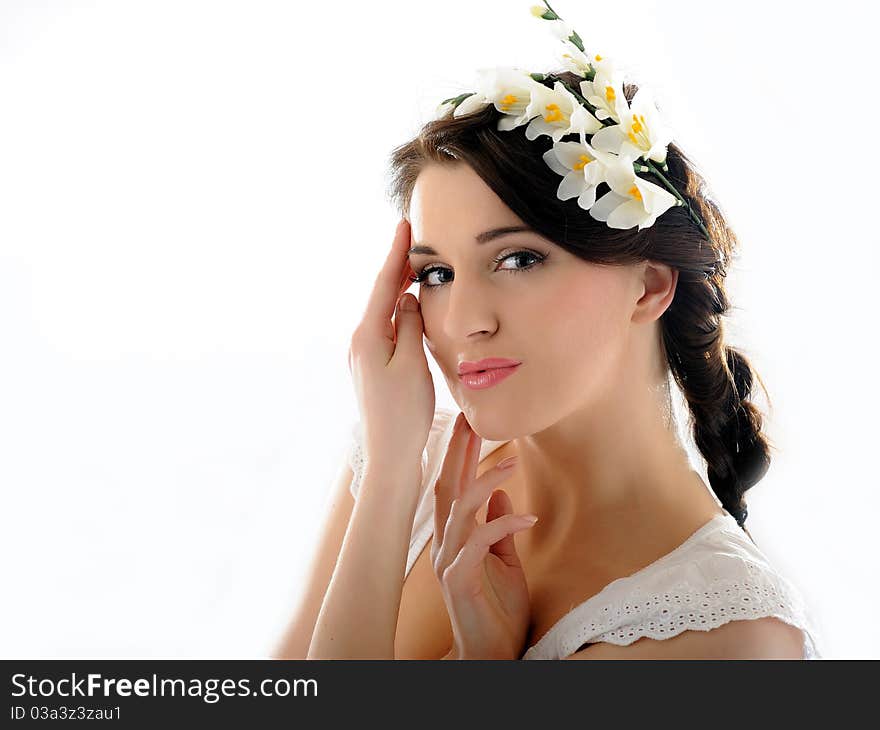 Beautiful fresh spring woman with flowers in her hair and pure skin