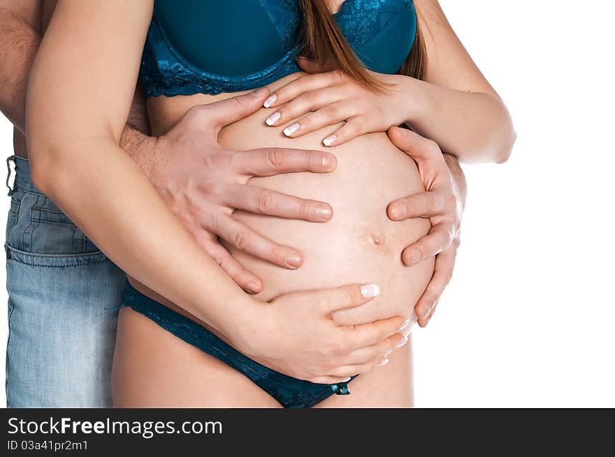 Man hugs stomachs of pregnant women