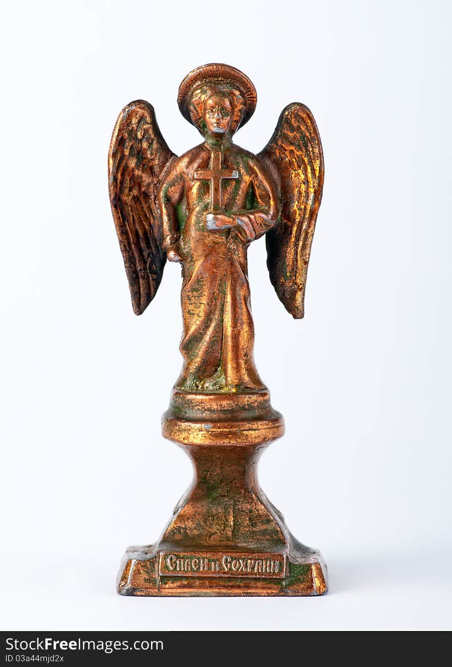 Antique copper statue in the shape of an angel on a white background