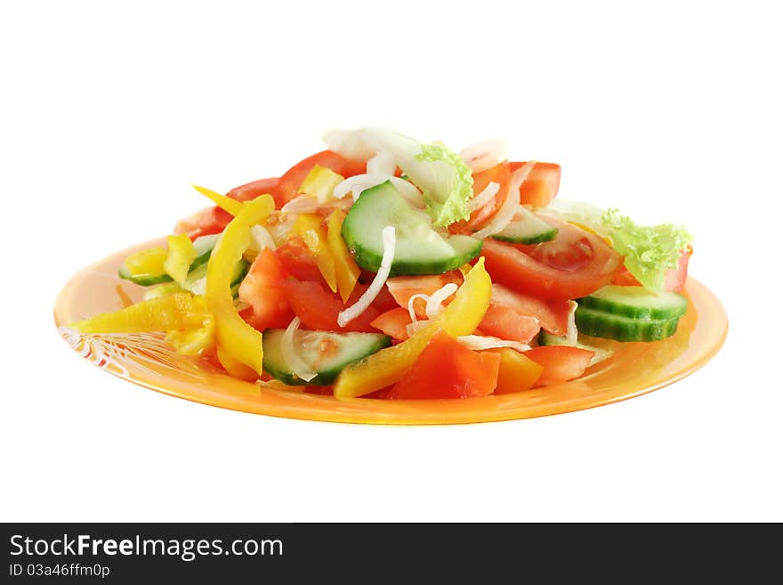 Salad made up of fresh cutted vegetables (tomato, cucumber, onion, sweet pepper and leaf lettuce), in orange glass plate, isolated on white. Salad made up of fresh cutted vegetables (tomato, cucumber, onion, sweet pepper and leaf lettuce), in orange glass plate, isolated on white