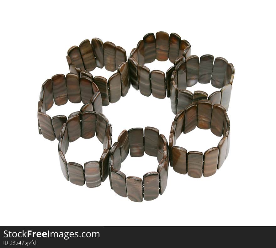 Color photograph of silver and wooden bracelets with a white background