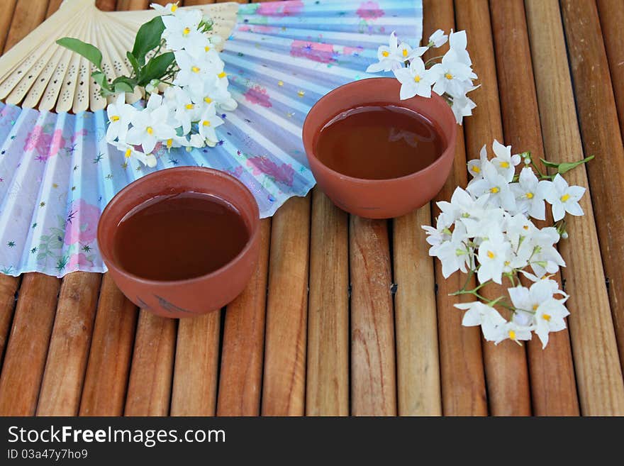 Two teacups with jasmine blossoms. Two teacups with jasmine blossoms