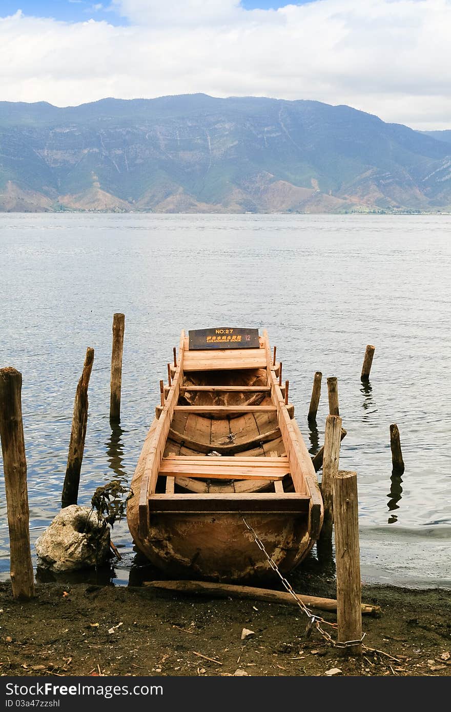 Old log boat at the lake bank