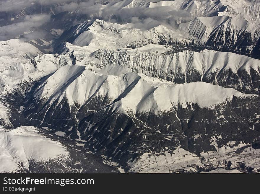 Photo taken from the airplane, somewhere above Alps during winter time. Photo taken from the airplane, somewhere above Alps during winter time.