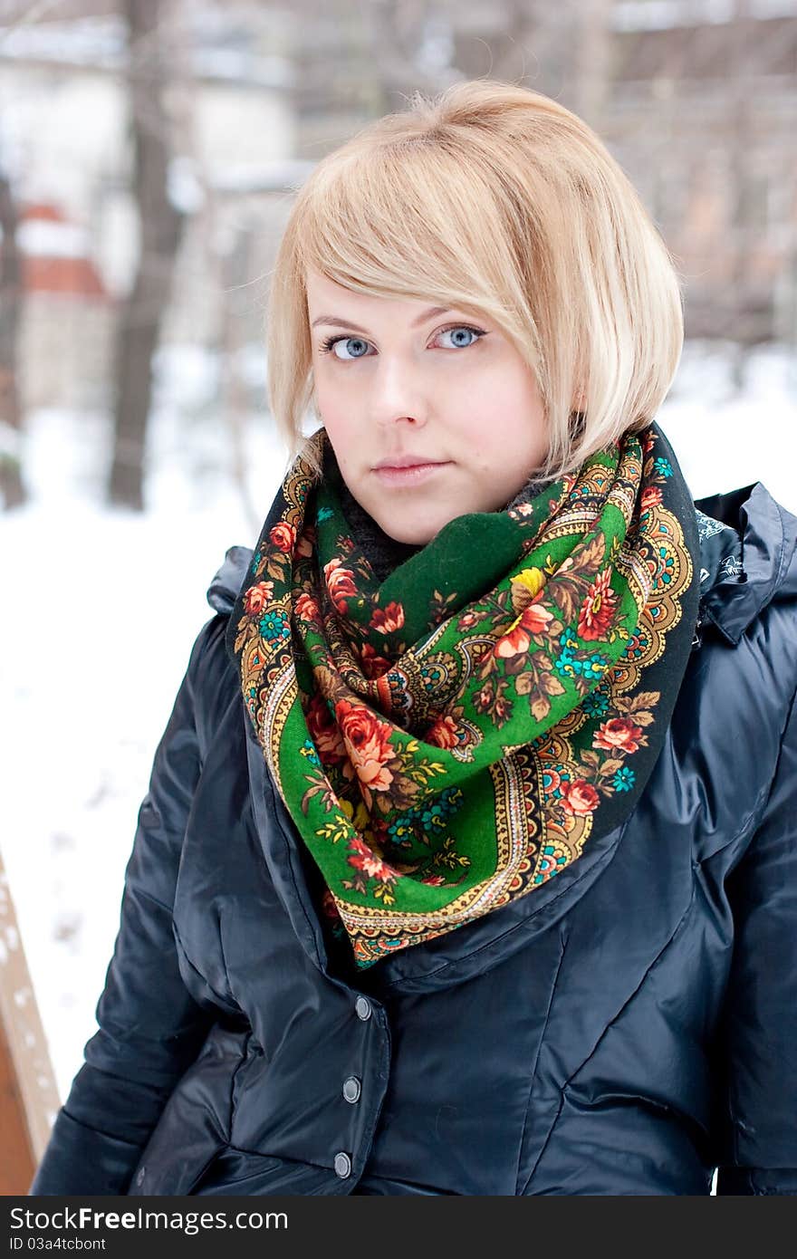 Frozen beautiful woman in winter clothing outdoors