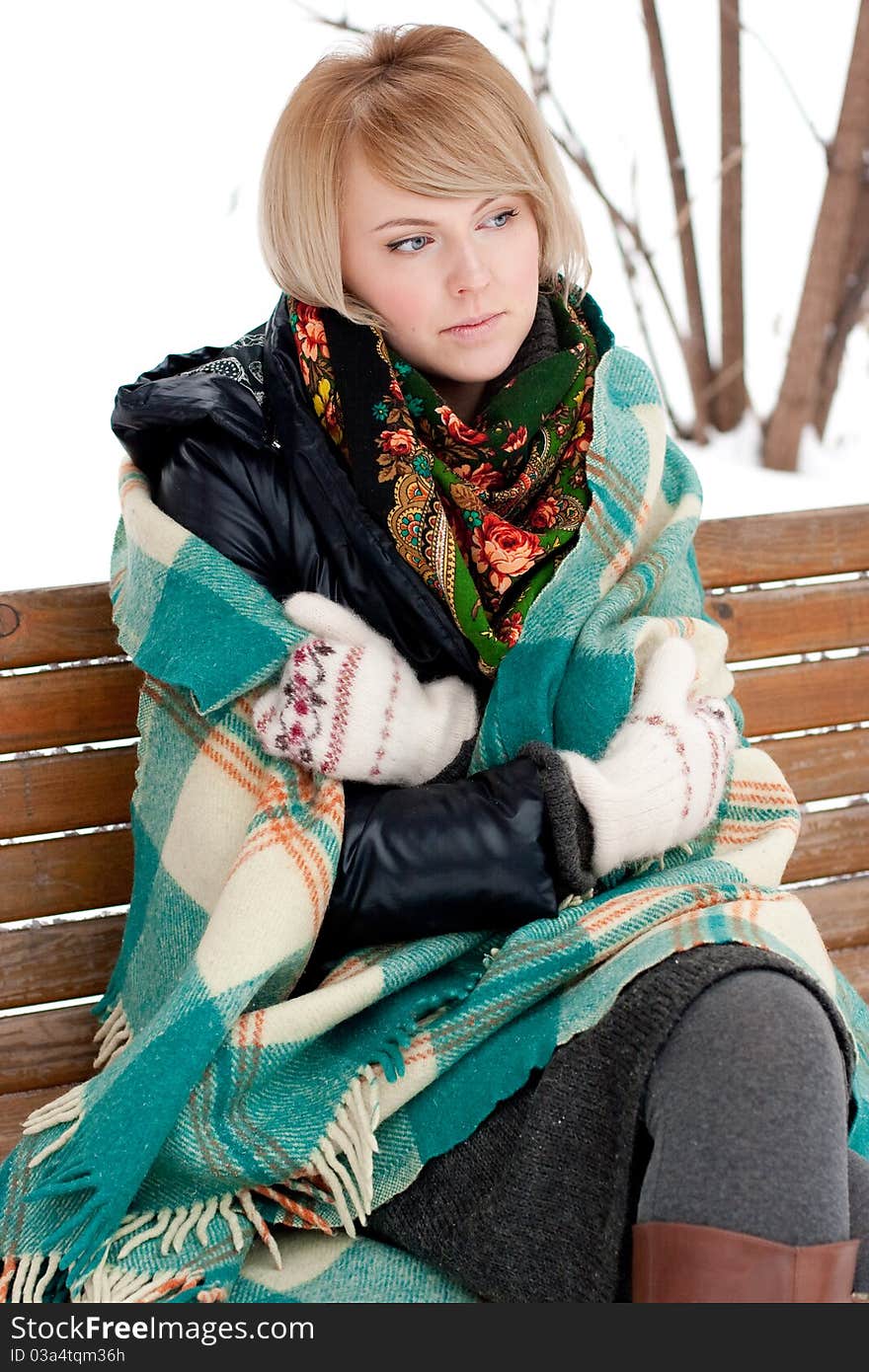 Frozen beautiful woman in winter clothing outdoors