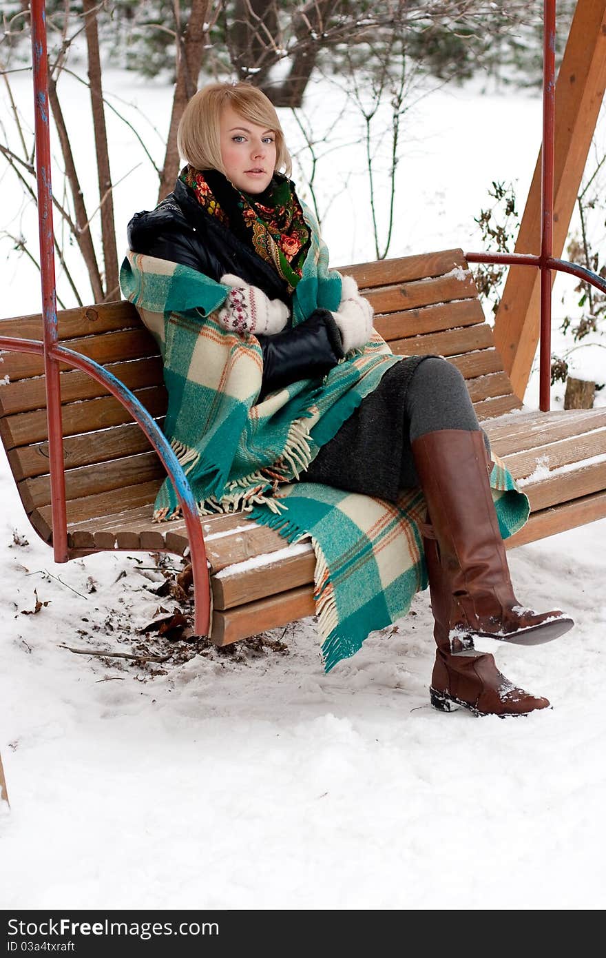 Frozen beautiful woman in winter clothing outdoors