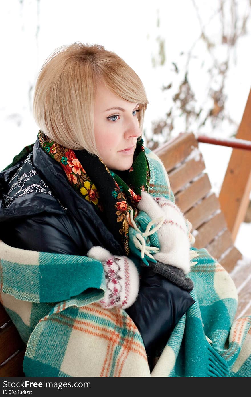 Frozen beautiful woman in winter clothing outdoors