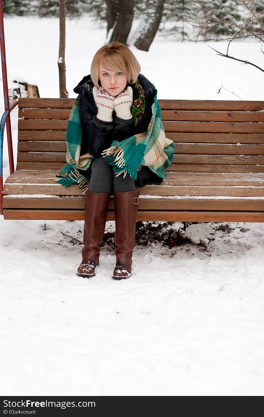 Frozen beautiful woman in winter clothing outdoors