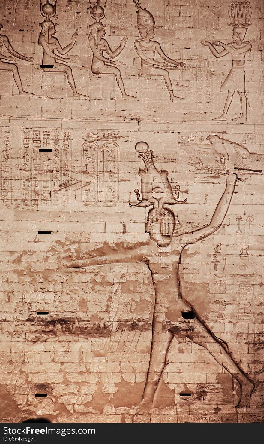 Egyptian images and hieroglyphs engraved on stone in Horus temple, Edfu, Egypt