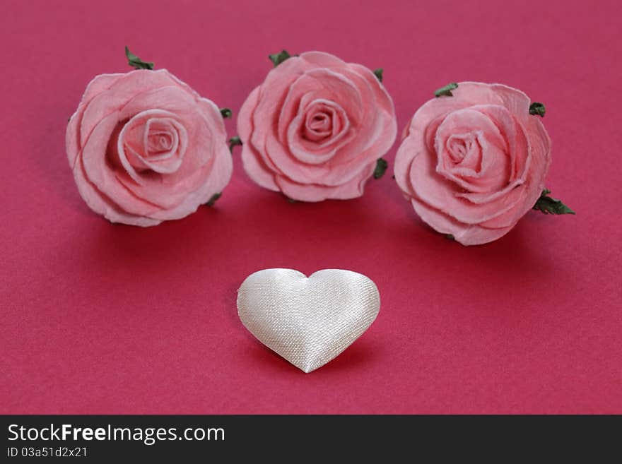 White heart and three pink roses. White heart and three pink roses