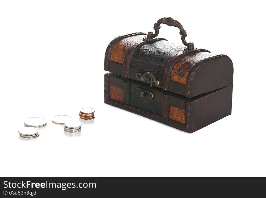 A front studio isolation shot on a white background of a small pirate chest withs some coins. A front studio isolation shot on a white background of a small pirate chest withs some coins.