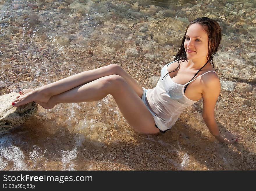 Beautiful young brunette woman on the sea beach. Beautiful young brunette woman on the sea beach