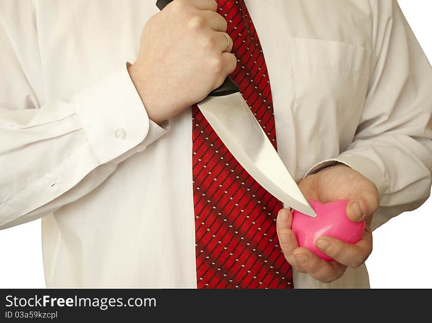 The man holds a knife and heart in hands