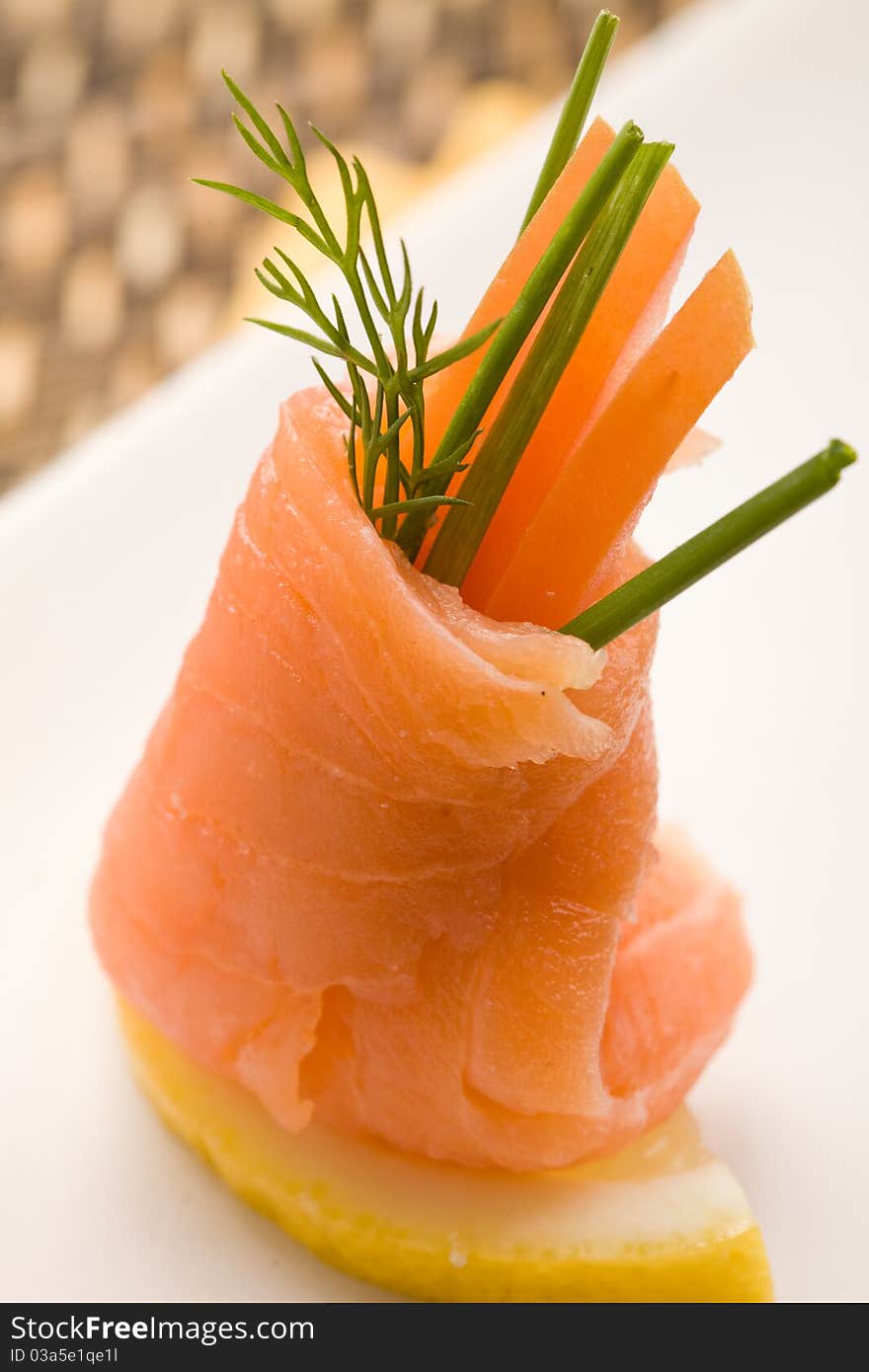 Photo fo delicious smoked salmon rolls with tomatoes inside