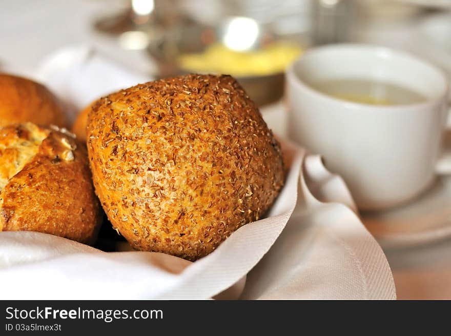 Freshly baked bread and buns with other breakfast utensils.