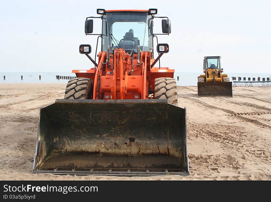 Two tractors on the beach.