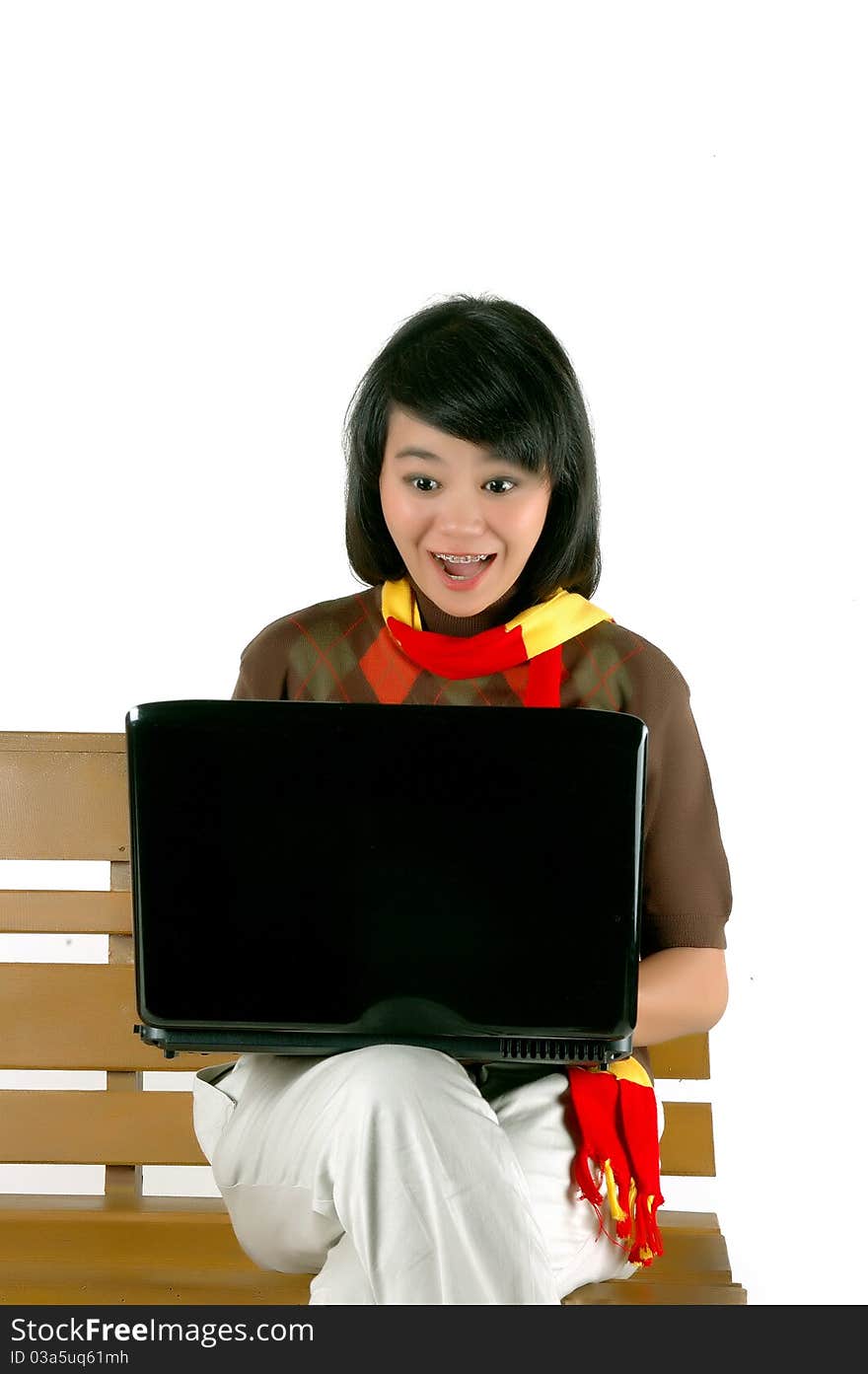 young woman surprised looking into laptop isolated on white background