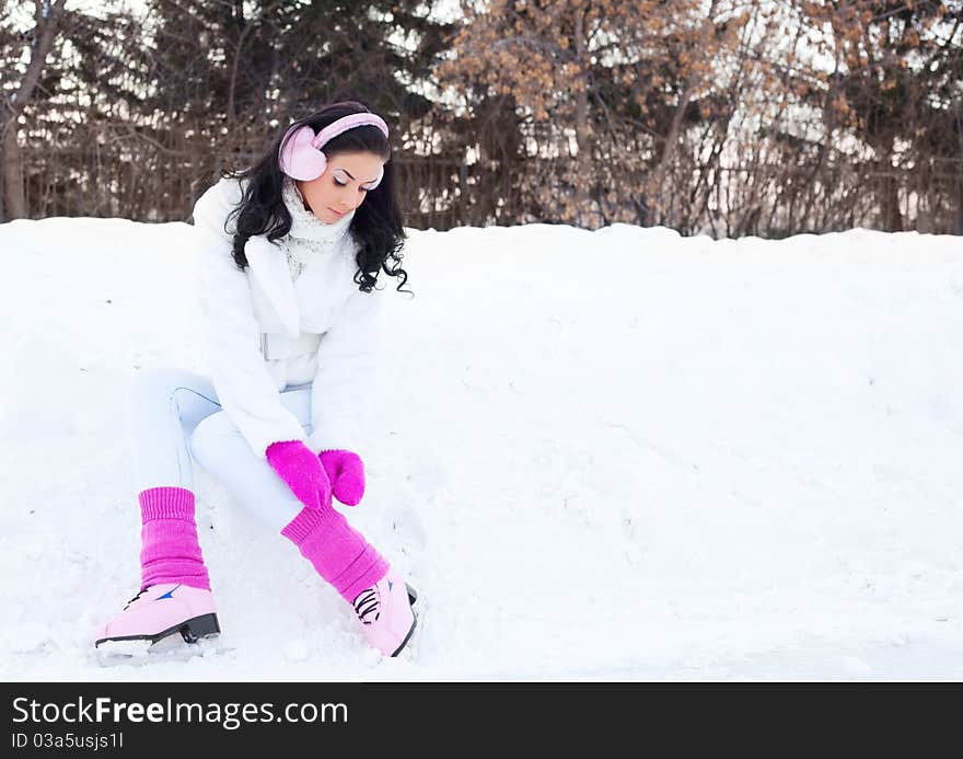 Happy beautiful girl wearing warm winter clothes ice skating. Happy beautiful girl wearing warm winter clothes ice skating