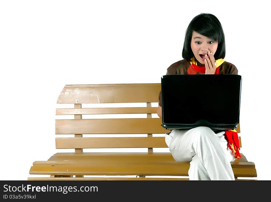 young woman surprised looking into laptop isolated on white background