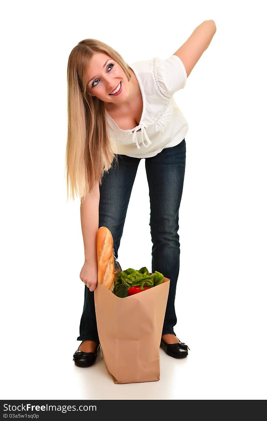 Woman carrying bag of groceries isolated on white