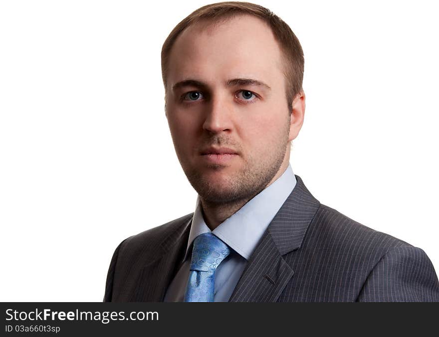 Portrait of an unshaven businessman in a gray suit with a white background