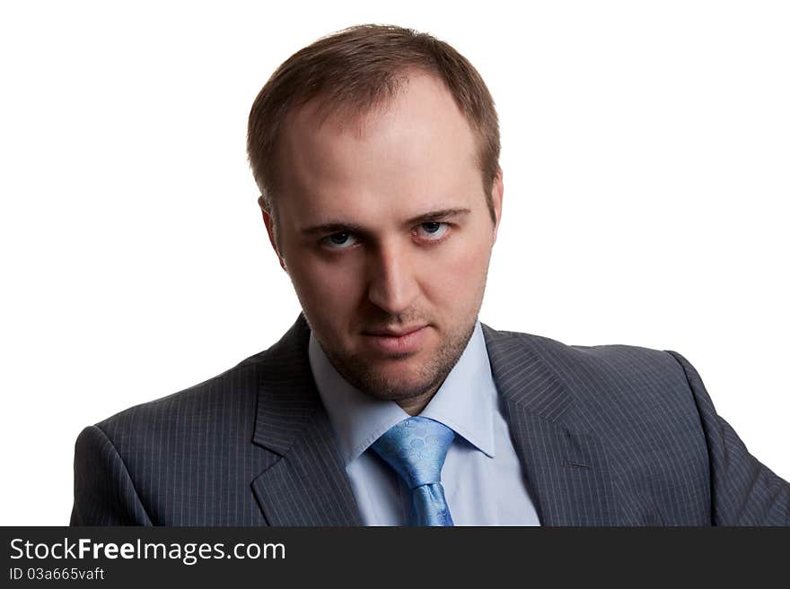 Portrait of an unshaven businessman in a gray suit with a white background