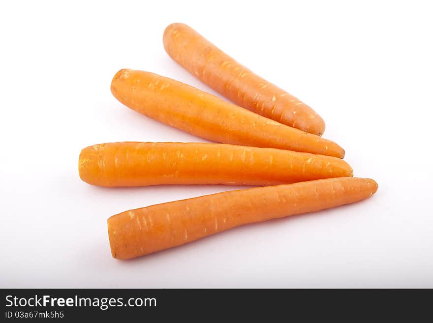 Four carrots on a white background