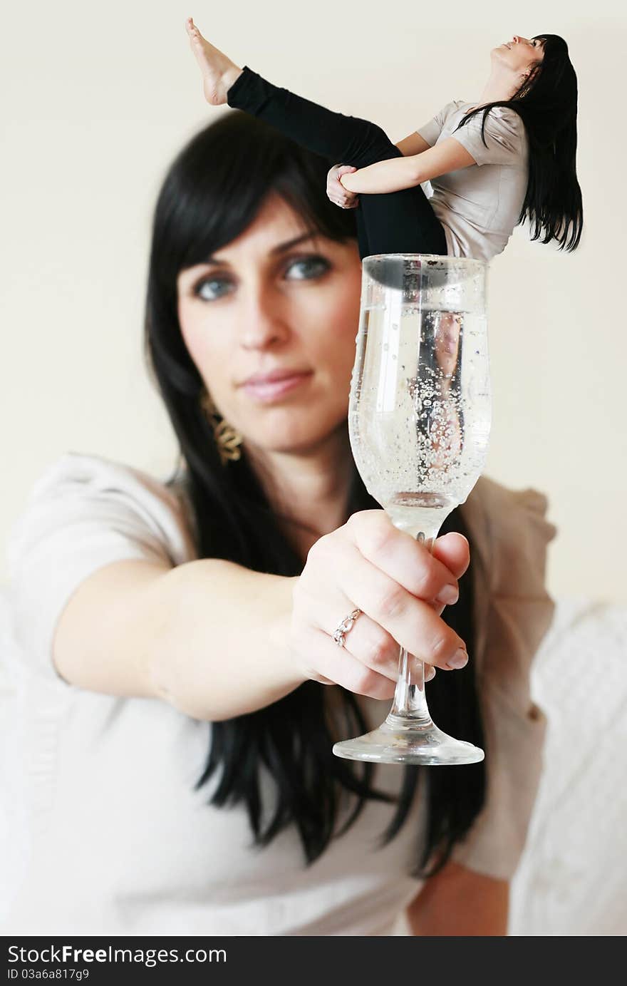 Woman having in her hand a glass with herself in it. Woman having in her hand a glass with herself in it