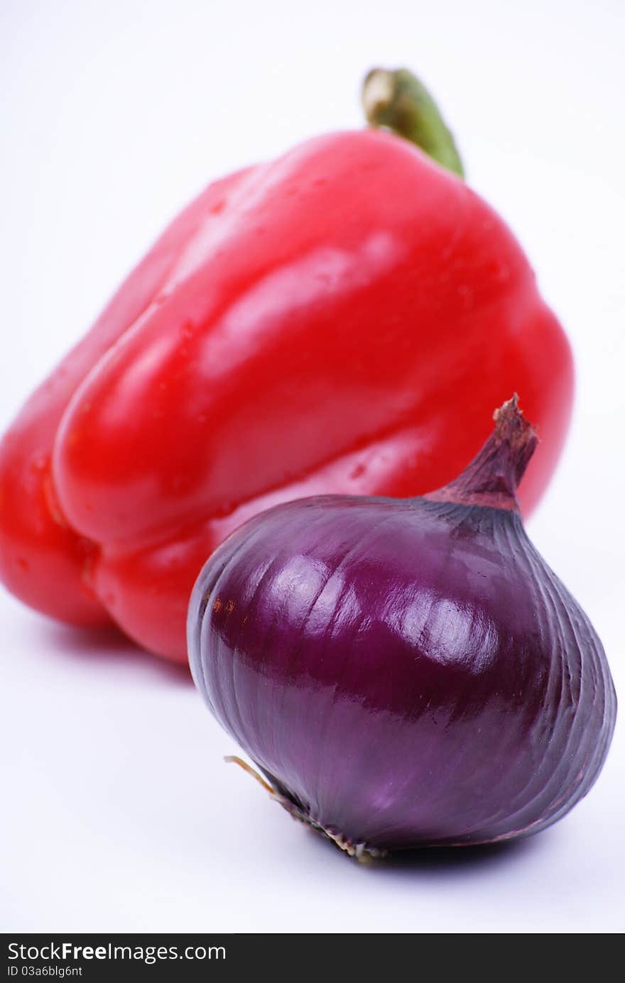 Pepper and violet onion isolated over white. Pepper and violet onion isolated over white