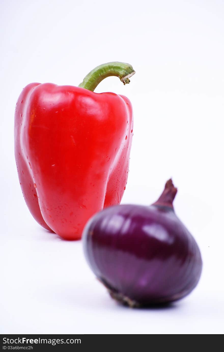 Pepper and violet onion isolated over white. Pepper and violet onion isolated over white