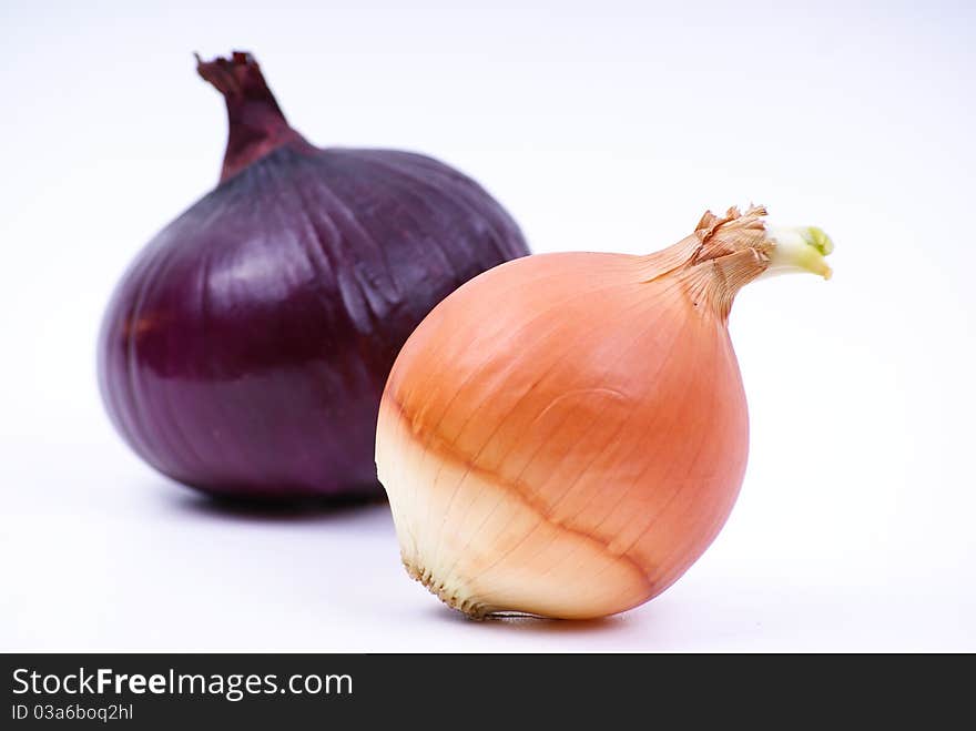 Image of two different onions on a white