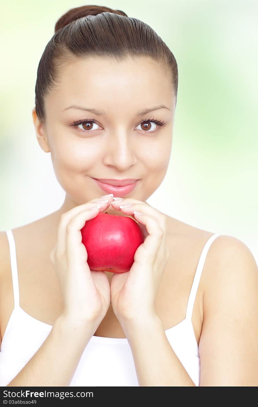 Girl holding red apple on green background. Girl holding red apple on green background