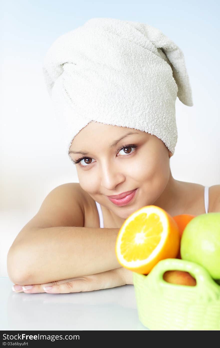 Girl with fruits on a light background