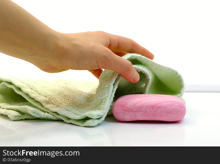 Female hand takes towel and soap by closeup