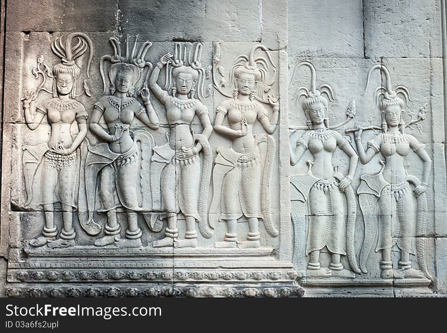 Apsaras, or celestial dancing girls, play out an eternal dance engraved in the ancient walls of Angkor, Cambodia. Apsaras, or celestial dancing girls, play out an eternal dance engraved in the ancient walls of Angkor, Cambodia.