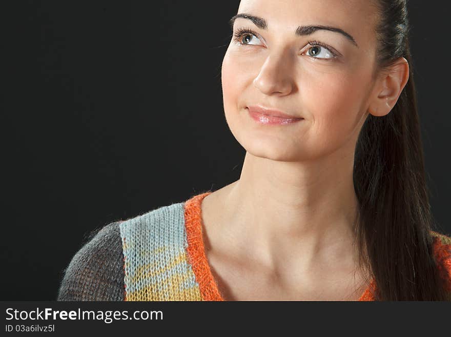 Portrait of young female in sweater looking up