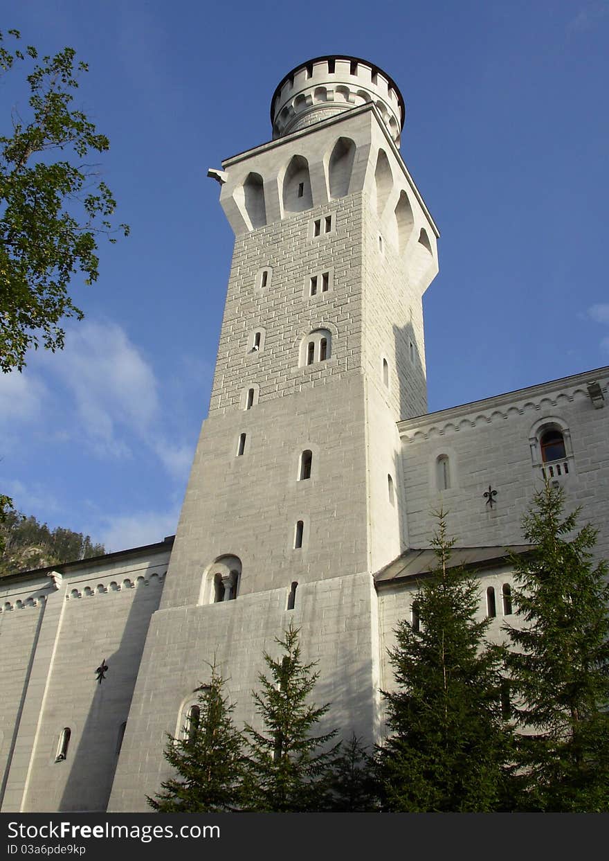 Neuschwanstein Castle is a 19th-century Gothic Revival palace on a rugged hill above the village of Hohenschwangau, Germany. Neuschwanstein Castle is a 19th-century Gothic Revival palace on a rugged hill above the village of Hohenschwangau, Germany