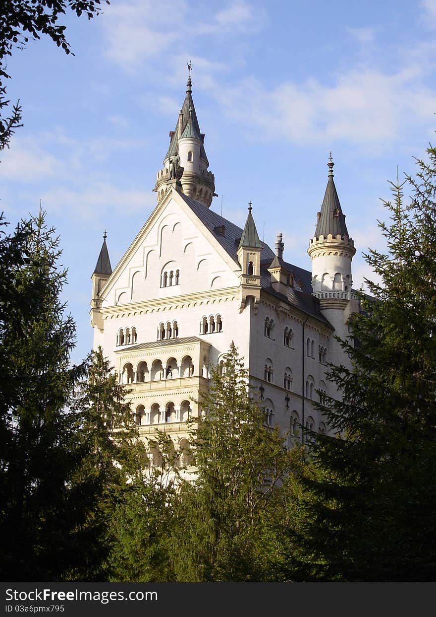 Neuschwanstein Castle is a 19th-century Gothic Revival palace on a rugged hill above the village of Hohenschwangau, Germany. Neuschwanstein Castle is a 19th-century Gothic Revival palace on a rugged hill above the village of Hohenschwangau, Germany