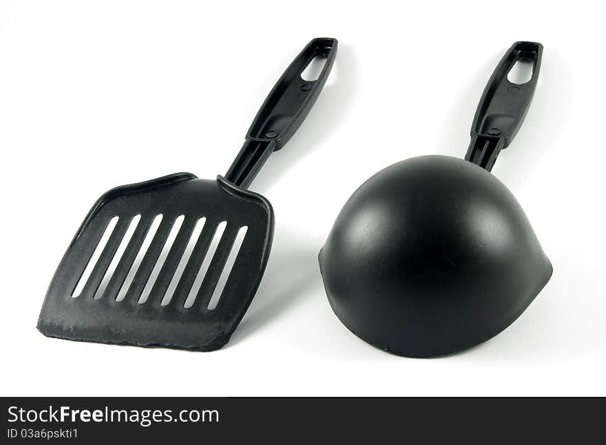 Two kitchen tools over the white surface