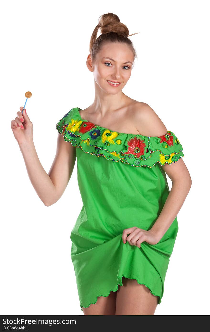 Young joyful female in green summer dress with candy isolated on white. Young joyful female in green summer dress with candy isolated on white