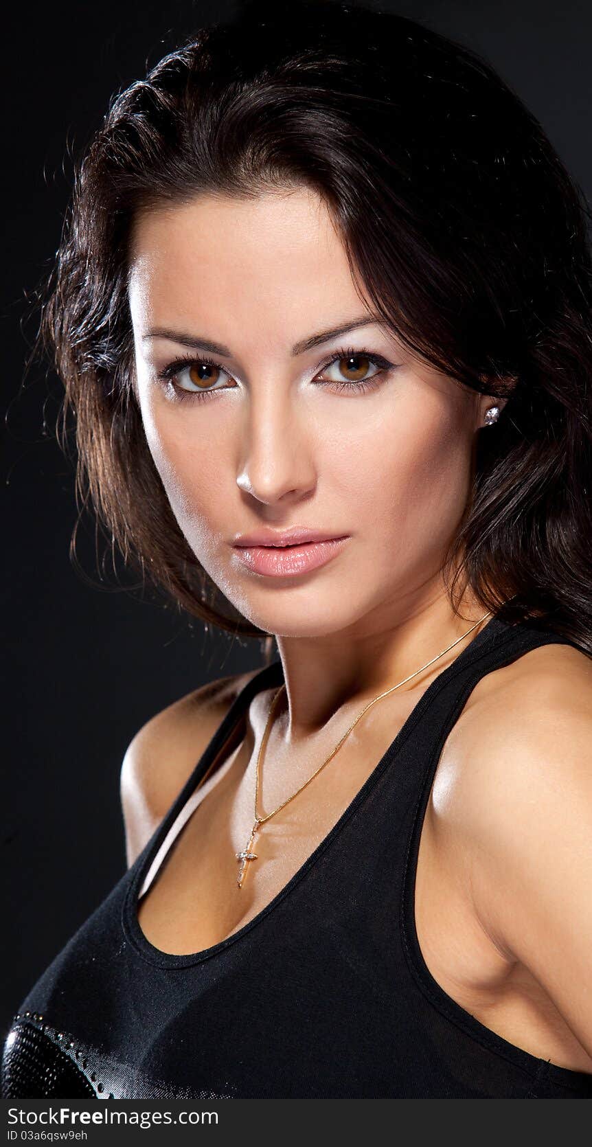 Studio portrait of young attractive brunette female on dark background. Studio portrait of young attractive brunette female on dark background