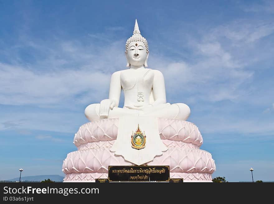 White image Buddha statue with blue sky.