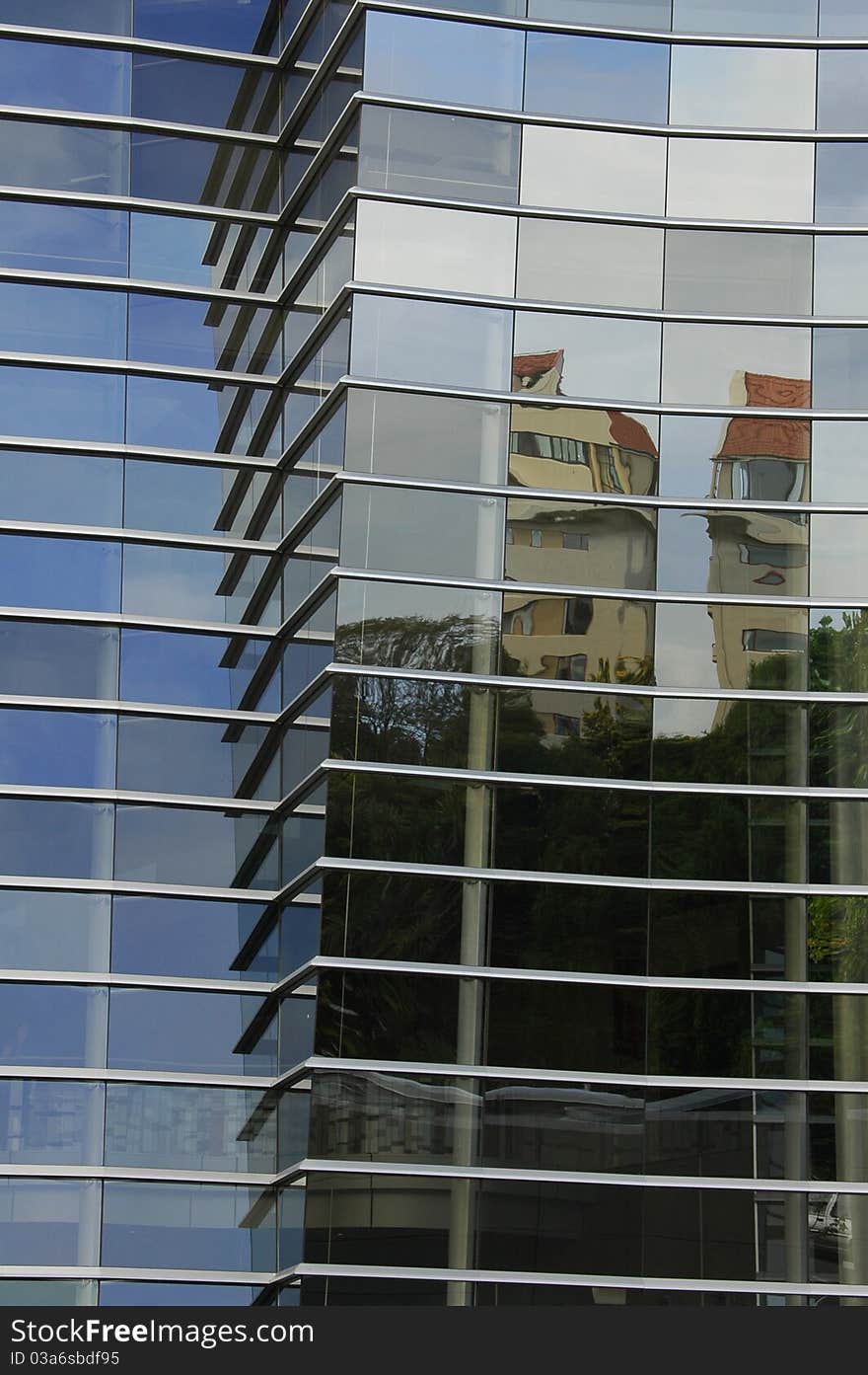 A reflection of a building in the windows of another tall building. A reflection of a building in the windows of another tall building