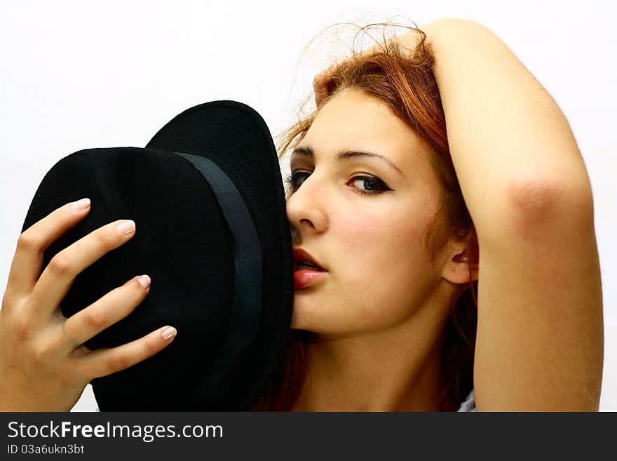 Elegant girl in a black hat isolated on white background. Elegant girl in a black hat isolated on white background